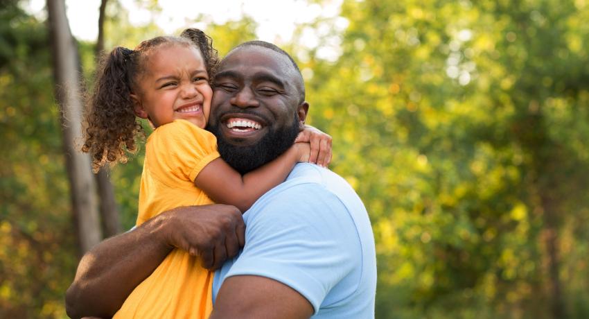 Man holding and hugging child