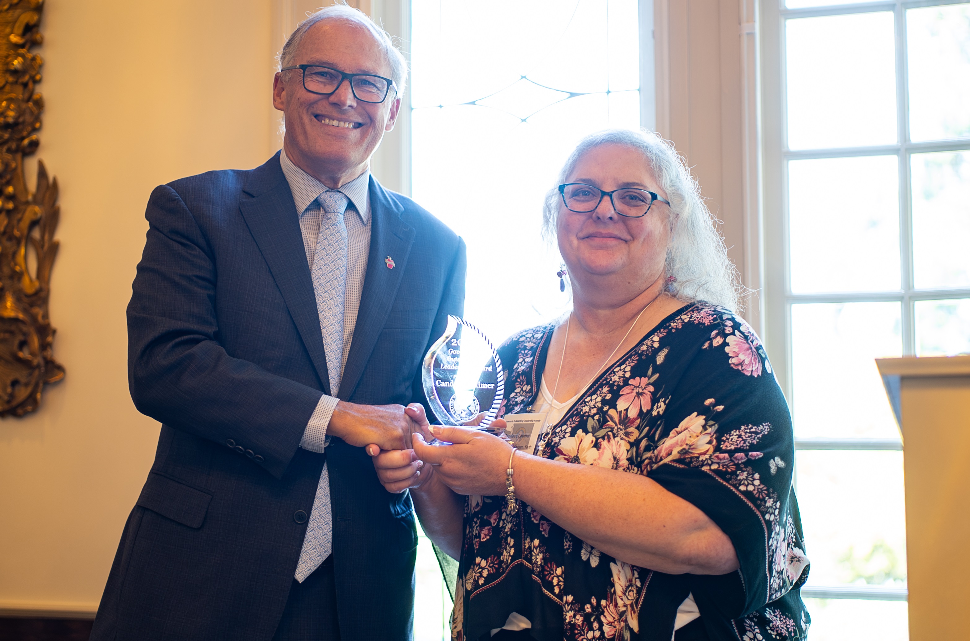 Candace Latimer receiving award from Gov. Inslee