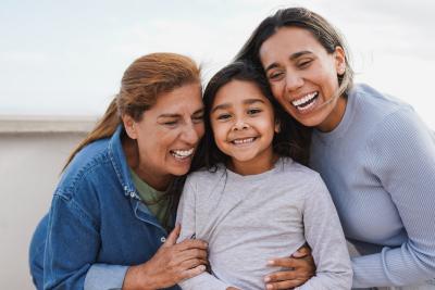 Happy latin multi generation family have tender moment together outdoor