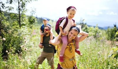 Family with backpacks in a park