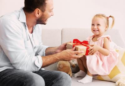 Father giving toddler a Christmas gift