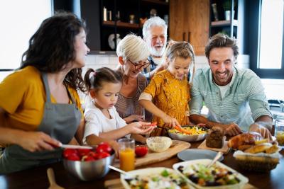 Family in a kitchen preparing food.