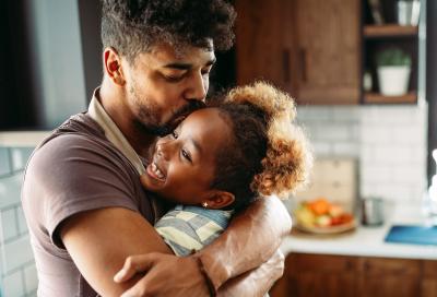 Father hugging daughter.