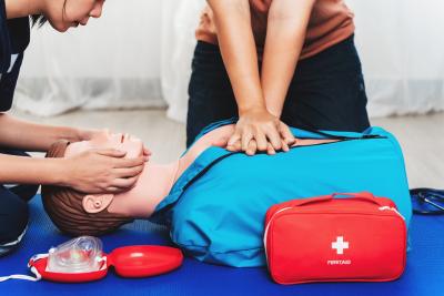 Person doing CPR chest compressions on a dummy