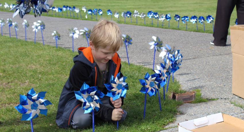 child planting pinwheels