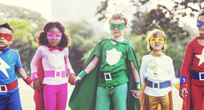 group of young children in superhero outfits