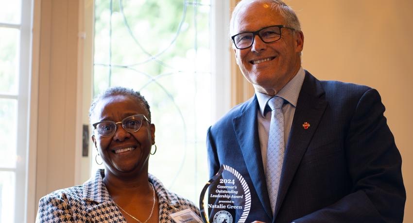 Natalie Green accepting an award from Gov. Inslee