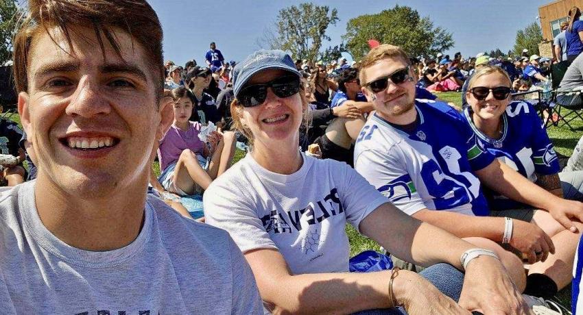 Staff from Canyon View, pictured sitting during a Seahawks Training Camp. 