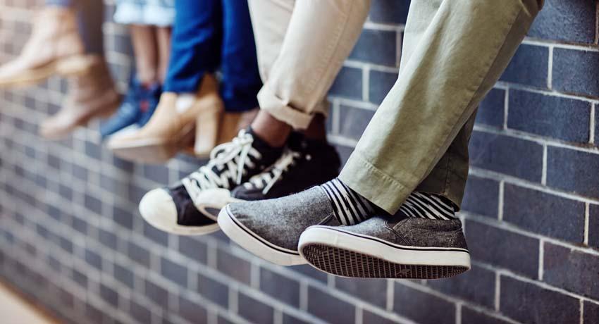 teens dangly legs over wall