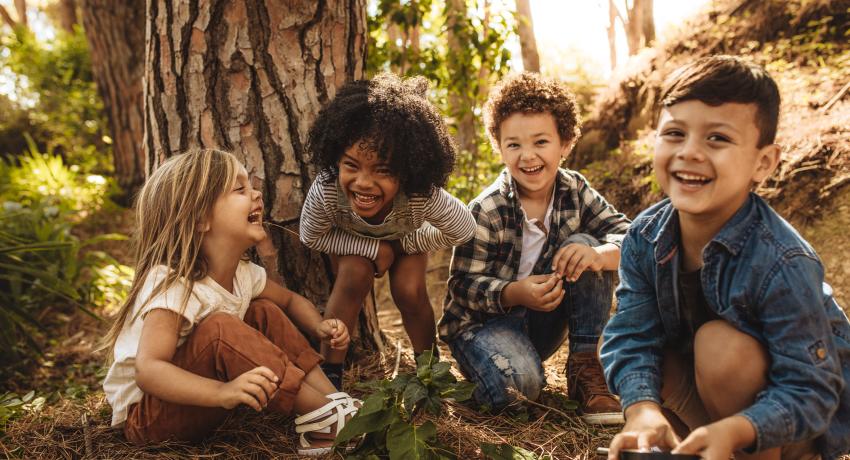 Children exploring in forest. 