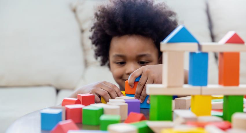 young child playing with blocks