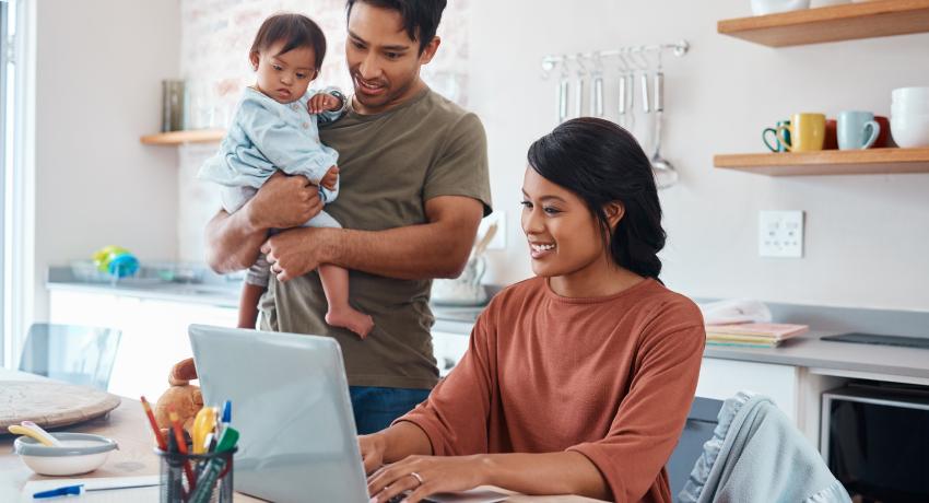 Young couple with toddler at computer