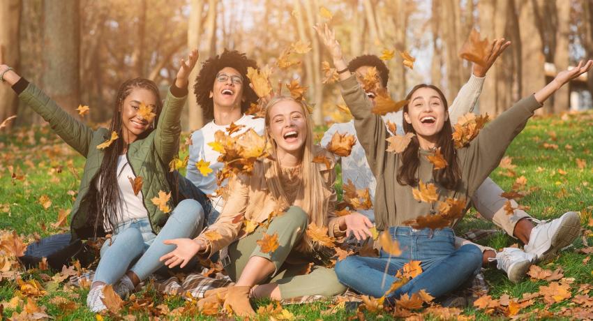 Youth playing the autumn leaves