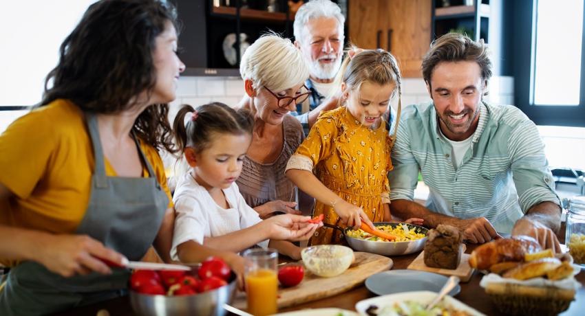 Family in a kitchen preparing food.