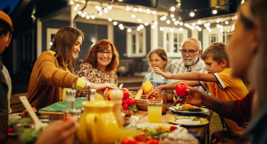 Large group eating at an outdoor table