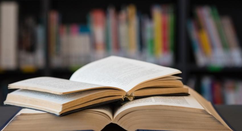 Open books on a desk in a library